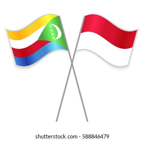 Comoran and Monegasque crossed flags. Comoros combined with Monaco isolated on white. Language learning, international business or travel concept.