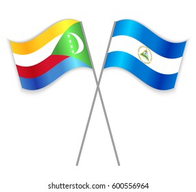 Comoran and Nicaraguan crossed flags. Comoros combined with Nicaragua isolated on white. Language learning, international business or travel concept.