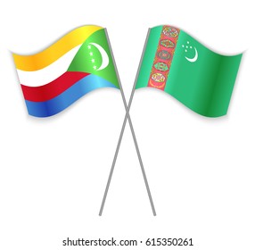 Comoran and Turkmen crossed flags. Comoros combined with Turkmenistan isolated on white. Language learning, international business or travel concept.