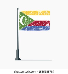 Comorian Island flag with scratches, vector flag of Comorian Island on flagpole with shadow