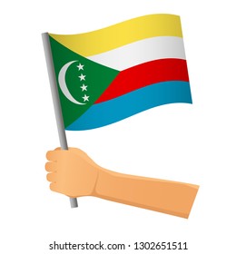 Comoros flag in hand. Patriotic background. National flag of Comoros vector illustration