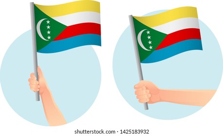 Comoros flag in hand. Patriotic background. National flag of Comoros vector illustration