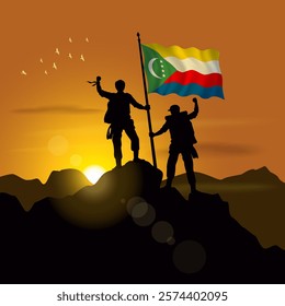 Comoros flag, silhouette of two climbers holding flags at sunset