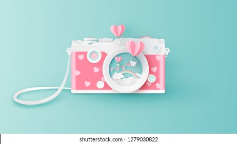 Compact camera design for Valentine's day with heart shape hot air balloons float out of the lens. Abstract of compact camera for Valentine's day. paper cut and craft style. vector, illustration.