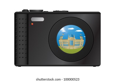 Compact digital camera with snapshot of Berlin's Parliament building on the lens. EPS10 vector graphic with transparency effect.