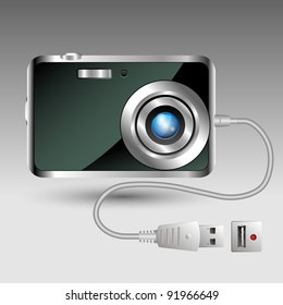 Compact digital photo camera with data cable connection - front view
