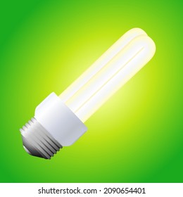 Bombilla eléctrica fluorescente compacta aislada en un fondo verde