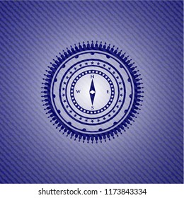 compass icon inside badge with denim texture