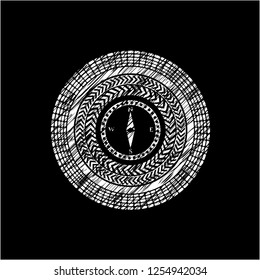 compass icon inside chalk emblem written on a blackboard