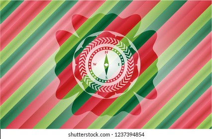 compass icon inside christmas badge.