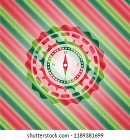compass icon inside christmas colors style badge.
