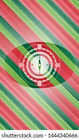 compass icon inside christmas colors badge.