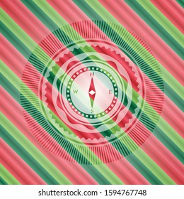 compass icon inside christmas colors badge.