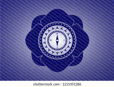 compass icon inside denim background