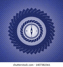 compass icon inside denim background