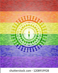 compass icon inside emblem on mosaic background with the colors of the LGBT flag
