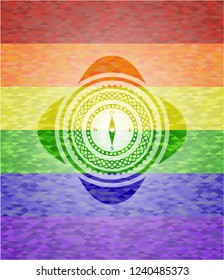 compass icon inside emblem on mosaic background with the colors of the LGBT flag