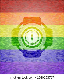compass icon inside emblem on mosaic background with the colors of the LGBT flag