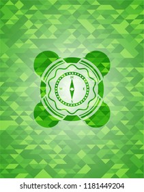 compass icon inside green emblem with triangle mosaic background