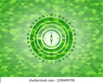 compass icon inside green emblem with mosaic background
