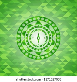 compass icon inside green mosaic emblem