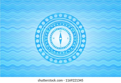 compass icon inside light blue water style badge.