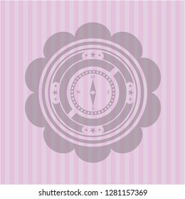 compass icon inside pink emblem
