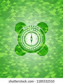 compass icon inside realistic green emblem. Mosaic background