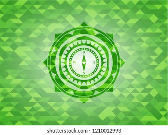compass icon inside realistic green mosaic emblem