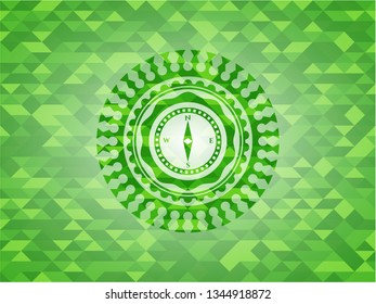 compass icon inside realistic green mosaic emblem