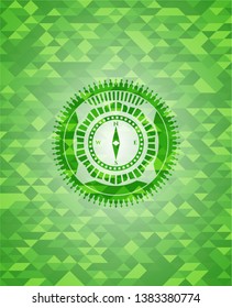 compass icon inside realistic green emblem. Mosaic background