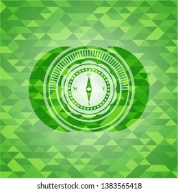 compass icon inside realistic green mosaic emblem