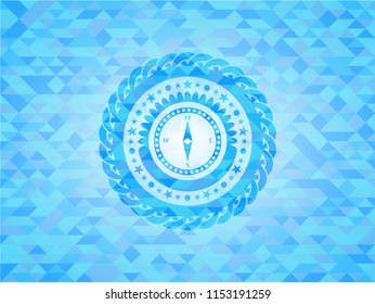 compass icon inside realistic light blue mosaic emblem