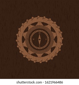 compass icon inside realistic wooden emblem