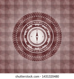 compass icon inside red seamless emblem with geometric pattern background.