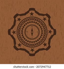 compass icon inside retro style wood emblem. 