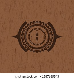 compass icon inside retro wood emblem