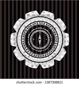compass icon inside silvery emblem or badge