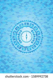 compass icon inside sky blue emblem with mosaic background
