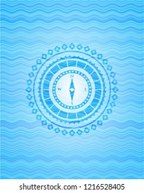 compass icon inside water wave concept badge background.