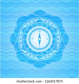 compass icon inside water wave representation badge.