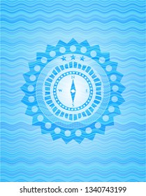 compass icon inside water wave style badge.