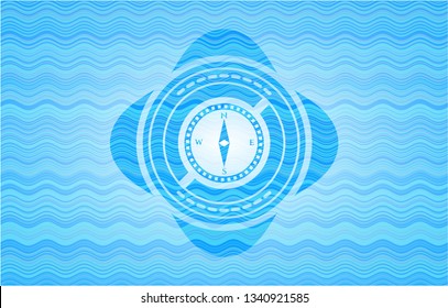 compass icon inside water wave concept style emblem.