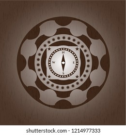 compass icon inside wooden emblem