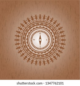 compass icon inside wooden emblem. Vintage.