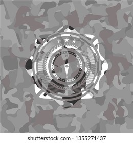 compass icon on grey camouflaged texture