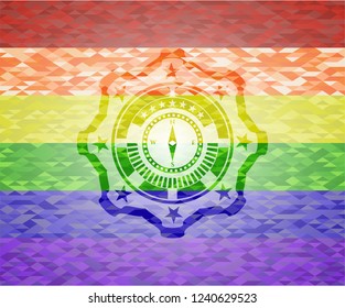 compass icon on mosaic background with the colors of the LGBT flag