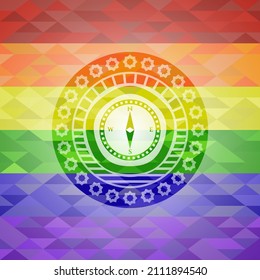 compass icon on mosaic background with the colors of the LGBT flag. 