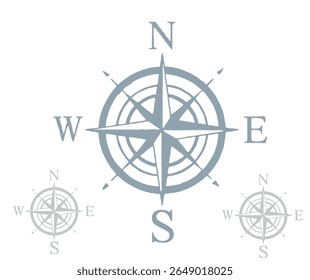 A compass rose illustration with cardinal directions and two smaller, faded compass roses. The image is in a muted, dusty blue color.