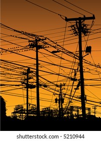 A complex maze of telephone poles and wires at sunset